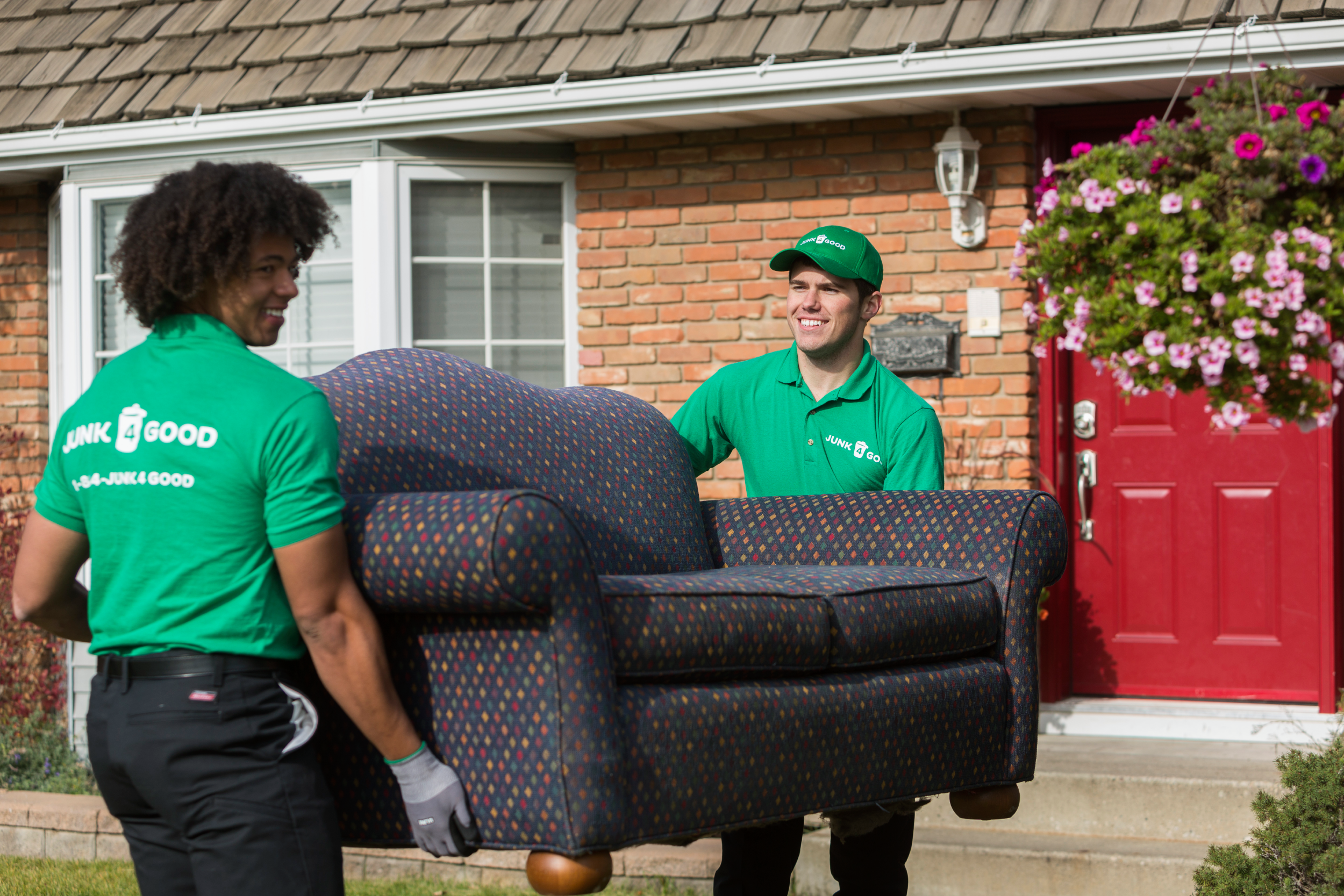 Two Junk 4 Good staff removing a couch from a home in Edmonton to take for donation.