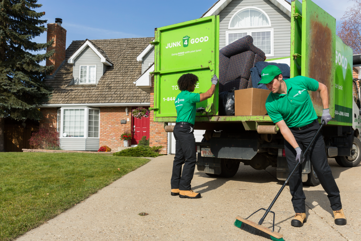 Junk 4 Good team members helping a customer with couch disposal in Edmonton.